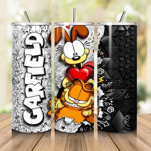 May include: A cylindrical tumbler featuring a black and white line art pattern with the word GARFIELD in large white letters, a central graphic of Garfield and Odie with a red heart, and a black geometric textured section with white doodles.