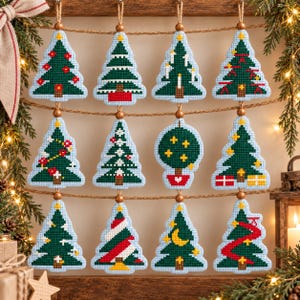 May include: Twelve cross-stitch ornaments hanging on twine, featuring various green Christmas tree designs with red, yellow, and white accents. Each ornament is shaped like a tree or a round topiary, suspended by a small wooden bead from a rustic string.