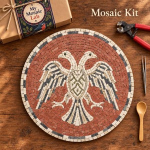 May include: A circular mosaic kit featuring a double-headed eagle design in red, white, and black tiles. The kit includes a cardboard box labeled My Mosaic Lab, red-handled nippers, metal tweezers, and a small wooden spoon for assembly.