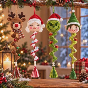 May include: Four crocheted Christmas ornaments hanging in a row. From left to right: a brown reindeer with a striped scarf, a white-haired figure in a red Santa hat, a green character in a red Santa hat, and an elf in a green hat. Each has a spiral tail.