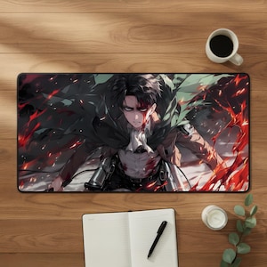 May include: A rectangular desk mat featuring a dark-haired anime character with a stern expression, wearing a green cape and tan uniform, surrounded by vibrant red energy effects and black smoke, set against a dark, dramatic background.