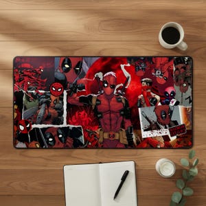 May include: A rectangular desk mat featuring a collage of Deadpool comic book illustrations in shades of red, black, and white. The design includes multiple action poses, a large central figure, and a small square photo with the text MAXIMUM EFFORT.
