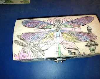 Reclaimed by Nature, Dragonflies and Lotus blossoms take over an old cemetery stash box
