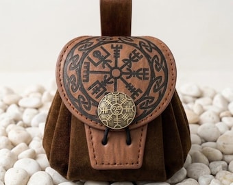 May include: A brown suede belt pouch featuring a circular flap embossed with a black Vegvisir symbol and intricate knotwork. The pouch is secured with a brass-toned metal button displaying a sun wheel design and a black cord closure loop.
