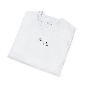 May include: A white short-sleeved t-shirt featuring a small black graphic on the chest depicting a hot air balloon with a trailing rope and a heart-shaped object. The inner collar displays the text "Provera" and a size label.