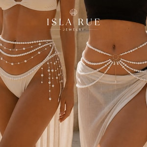 May include: Two waist chains featuring white pearl beads. The left chain has multiple draped strands with hanging pearl accents. The right chain features a central gold ring connecting several draped pearl strands. Text reads ISLA RUE JEWELRY.