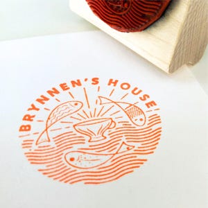 May include: Orange rubber stamp with the text "BRYNEN'S HOUSE" in a circle. Inside the circle is a stylised image of a bowl with three fish swimming around it.
