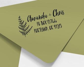 May include: A green envelope with a black fern design and the text "Amanda + Chris, PO Box 13744, Portland, OR 97213" printed on it.