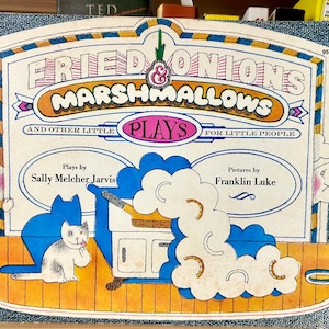 May include: A vintage paperback book titled Fried Onions & Marshmallows and Other Little Plays for Little People by Sally Melcher Jarvis with illustrations by Franklin Luke, featuring a white cat, a stove, and a blue border on the cover.