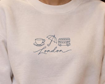 Sudadera de Londres, sudadera con cuello redondo y diseño minimalista de autobús y paraguas, suéter urbano con estampado lineal, regalo de Londres para ella, suéter navideño de Inglaterra.