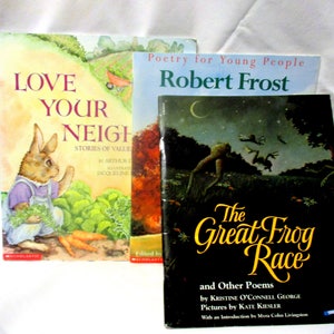 May include: Three children's books are displayed, featuring colorful illustrations and titles. The books include "Love Your Neighbor," "Poetry for Young People Robert Frost," and "The Great Frog Race and Other Poems."