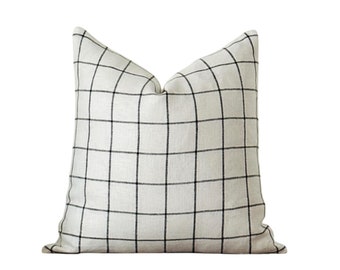 May include: A white pillow with a black and white checkered pattern.