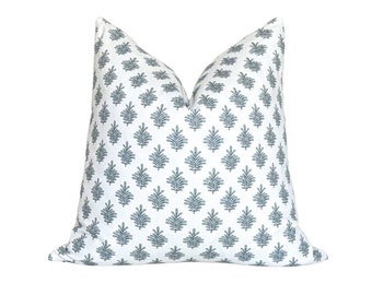 May include: A white pillow with a blue and white floral pattern. The pillow is made of a soft, comfortable fabric and is perfect for adding a touch of style to any room.