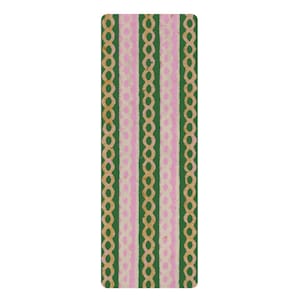 May include: A rectangular mat featuring a repeating vertical pattern of dark green stripes alternating with light pink stripes. The design includes thin, tan-coloured chain-link or oval-shaped motifs running vertically along the centre of each stripe.