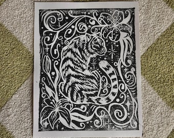 Grabado en linóleo de un tigre caprichoso con lirios