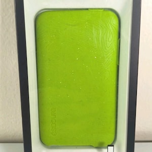 May include: A lime green Incase protective cover for an iPod touch 2nd generation, encased in its original black retail packaging. The cover features a subtle topographic line pattern and the Incase logo. The packaging displays the text Protective Cover for iPod touch 2nd generation and lists 8GB 16GB 32GB 64GB.