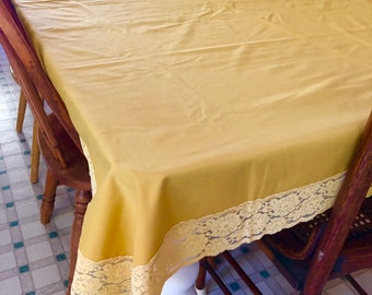 Simple elegance. Vintage gold tablecloth with lace trim. Rectangle