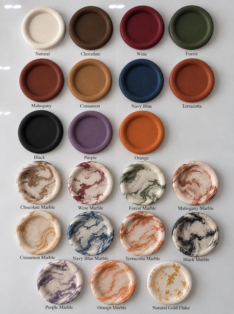 May include: A collection of round, shallow trays arranged in rows. The top three rows feature solid colors including natural, chocolate, wine, forest, mahogany, cinnamon, navy blue, terracotta, black, purple, and orange. The bottom rows show marble patterns and a natural gold flake finish, each labeled with its corresponding color name.