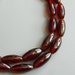 Vintage Czech Metallic Ruby Red glass long rice barrel ,Oval beads long strand