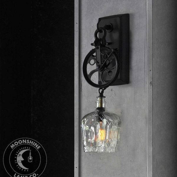 Industrial Pulley Wheel Wall Sconce With Recycled Crown Royal Glass Bottle Lamp Shade and Vintage Style Edison Bulb