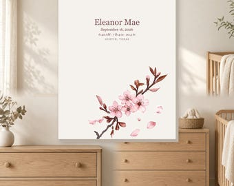 Op de afbeelding: Een rechthoekige wandprint met een witte achtergrond en een aquarelillustratie van een kersenbloesemtak in roze en bruin. De tekst luidt Eleanor Mae, 16 september 2026, 06:42 uur, 3,29 kg, 52,07 cm, Austin, Texas.