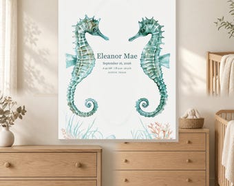 May include: A rectangular wall art print featuring two watercolor seahorses in shades of teal facing each other. The text reads Eleanor Mae, September 16, 2026, 6:42 AM, 7 lb 4 oz, 20.5 in, Austin, Texas. Below are illustrations of coral and seaweed.