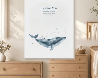 May include: A white rectangular wall art print featuring a watercolor blue whale with a small sailboat on its back. The text reads Eleanor Mae, September 16, 2026, 6:42 AM, 7 lb 4 oz, 20.5 in, and Austin, Texas, with small gold stars and a crescent moon.