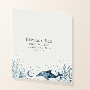 Angled close view of ocean personalized baby birth stats canvas showing the printed wrapped edge.