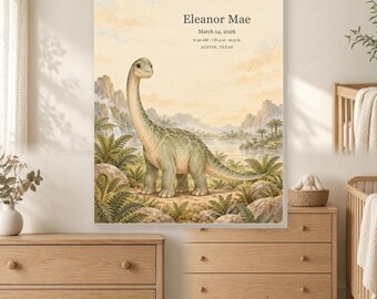 May include: A rectangular wall art print featuring a green long-necked dinosaur in a prehistoric landscape with mountains and water. The text reads: Eleanor Mae, March 14, 2026, 6:42 AM, 7 lb 4 oz, 20.5 in, AUSTIN, TEXAS, in a soft, neutral color palette.
