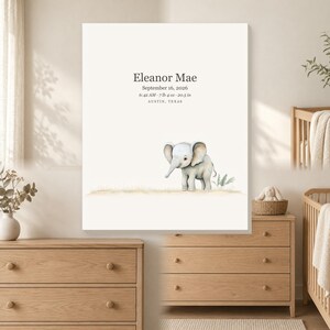 May include: A rectangular wall art print featuring a watercolor illustration of a baby elephant standing on a grassy patch. The text reads: Eleanor Mae, September 16, 2026, 6:42 AM, 7 lb 4 oz, 20.5 in, and AUSTIN, TEXAS, in a dark grey serif font.