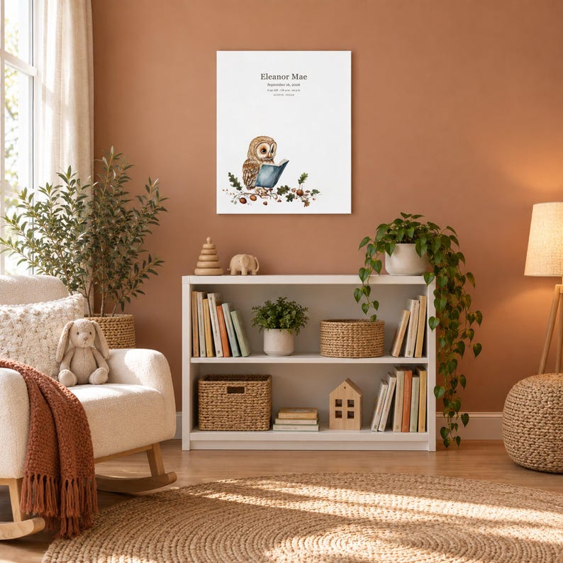 Storybook owl canvas in a nursery on a terracotta wall above a white bookshelf, showing sample name Eleanor Mae and birth details.