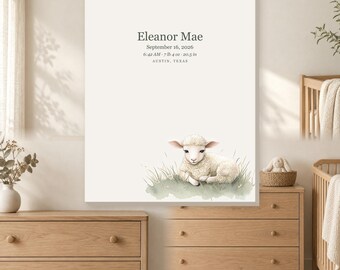 May include: A rectangular wall art print featuring a cream background with the text Eleanor Mae, September 16, 2026, 6:42 AM, 7 lb 4 oz, 20.5 in, Austin, Texas. At the bottom, a watercolor illustration shows a fluffy white lamb lying in green grass.