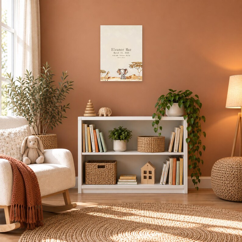 Safari birth stats sign in a nursery on a terracotta wall above a white bookshelf, showing sample name Eleanor Mae and birth details.