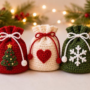 May include: Three small crochet drawstring pouches in red, cream, and dark green. The red pouch features a green Christmas tree, the cream pouch has a red heart, and the green pouch displays a white snowflake. Each bag has a white or red cord.