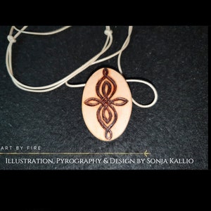 May include: A wooden pendant with a brown Celtic knot design on a white cord. The pendant is oval shaped and has a light brown wood colour. The text "ART BY FIRE ILLUSTRATION, PYROGRAPHY & DESIGN BY SONJA KALLIO" is at the bottom of the image.