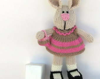 Bunny rabbit knitted toy.  Plush doll for children. Soft, cuddly baby toy.