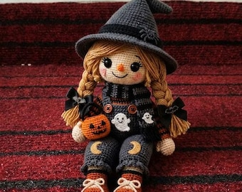 May include: A crocheted doll wearing a gray witch hat with a spider, a striped scarf, and gray overalls featuring moon patches. The doll has blonde braided hair with black bows, holds a small orange jack-o'-lantern, and wears brown boots.
