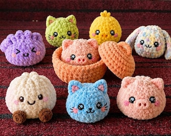May include: A collection of small, round, plush crochet animals and characters including a purple dumpling, green cat, yellow chick, pastel bunny, white bun, blue cat, and two pink pigs, one of which is nestled inside a small orange basket.