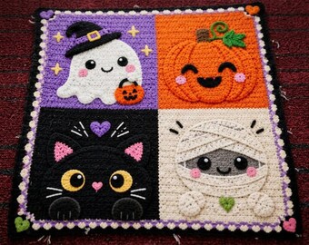 May include: A square crochet blanket featuring four panels with Halloween characters: a white ghost in a black hat, an orange pumpkin, a black cat, and a white mummy. The border is decorated with small hearts and a scalloped edge in purple and white.