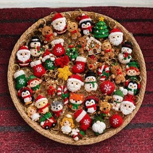 May include: A collection of small, crocheted Christmas-themed keychains arranged in a round woven basket. The items include figures of Santa Claus, snowmen, gingerbread people, reindeer, elves, angels, Christmas trees, stockings, and candy canes.