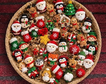 May include: A collection of small, crocheted Christmas-themed keychains arranged in a round woven basket. The items include figures of Santa Claus, snowmen, gingerbread people, reindeer, elves, angels, Christmas trees, stockings, and candy canes.