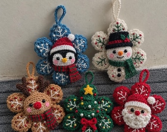 May include: Five crocheted ornaments featuring a penguin in a Santa hat, a snowman in a top hat, a reindeer, a Christmas tree, and Santa Claus. Each figure is centered on a snowflake-shaped base with a loop for hanging.