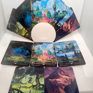 May include: A collection of five rectangular trading cards featuring colorful illustrations of My Little Pony characters in various landscapes, including a forest, plains, island, swamp, and mountain, arranged around a central white circular disc.