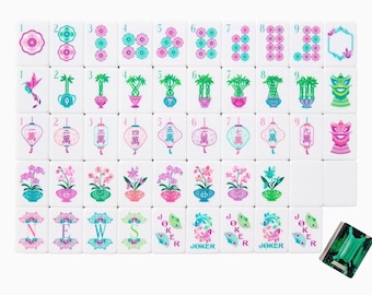 May include: A set of white mahjong tiles featuring colorful illustrations of flowers, bamboo, lanterns, and dragons. The tiles include numbered suits, directional letters N, E, W, S, and joker tiles with fan graphics, plus one dark green translucent tile.