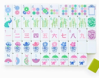 May include: A set of white Mahjong tiles arranged in a grid, featuring colorful illustrations of peacocks, bamboo, flowers, fans, and monkeys. The tiles include numbers one through nine in both Arabic and Chinese numerals, plus Joker tiles.
