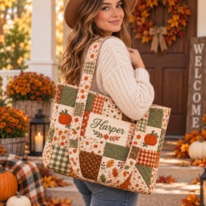 May include: A quilted tote bag featuring a patchwork design with autumn-themed patterns including orange pumpkins, brown leaves, and green plaid squares. The center panel displays the name Harper embroidered in dark green script with floral accents.