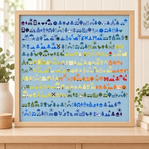 May include: A square cross-stitch embroidery in a light wooden frame featuring rows of small, colourful icons arranged in a gradient pattern. The design includes various symbols like houses, trees, vehicles, animals, and weather icons in blue, green, yellow, orange, and red.