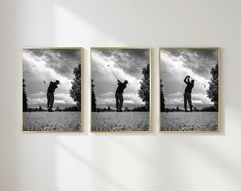 May include: A set of three black and white framed wall art prints depicting a golfer in motion. Each vertical print shows a different stage of a golf swing on a grassy course under a cloudy sky, all enclosed in thin gold frames.