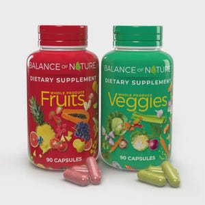 May include: Two plastic bottles of Balance of Nature dietary supplements, one red labeled Fruits and one green labeled Veggies, each containing 90 capsules. Several loose capsules in matching colors are placed in front of the bottles.
