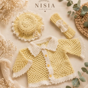 May include: A crochet baby set featuring a pale yellow cardigan with a white collar and three yellow buttons, a matching round sun hat with a white scalloped edge, and a rectangular headband with a small white bow, all with Nisia Canarias branding.